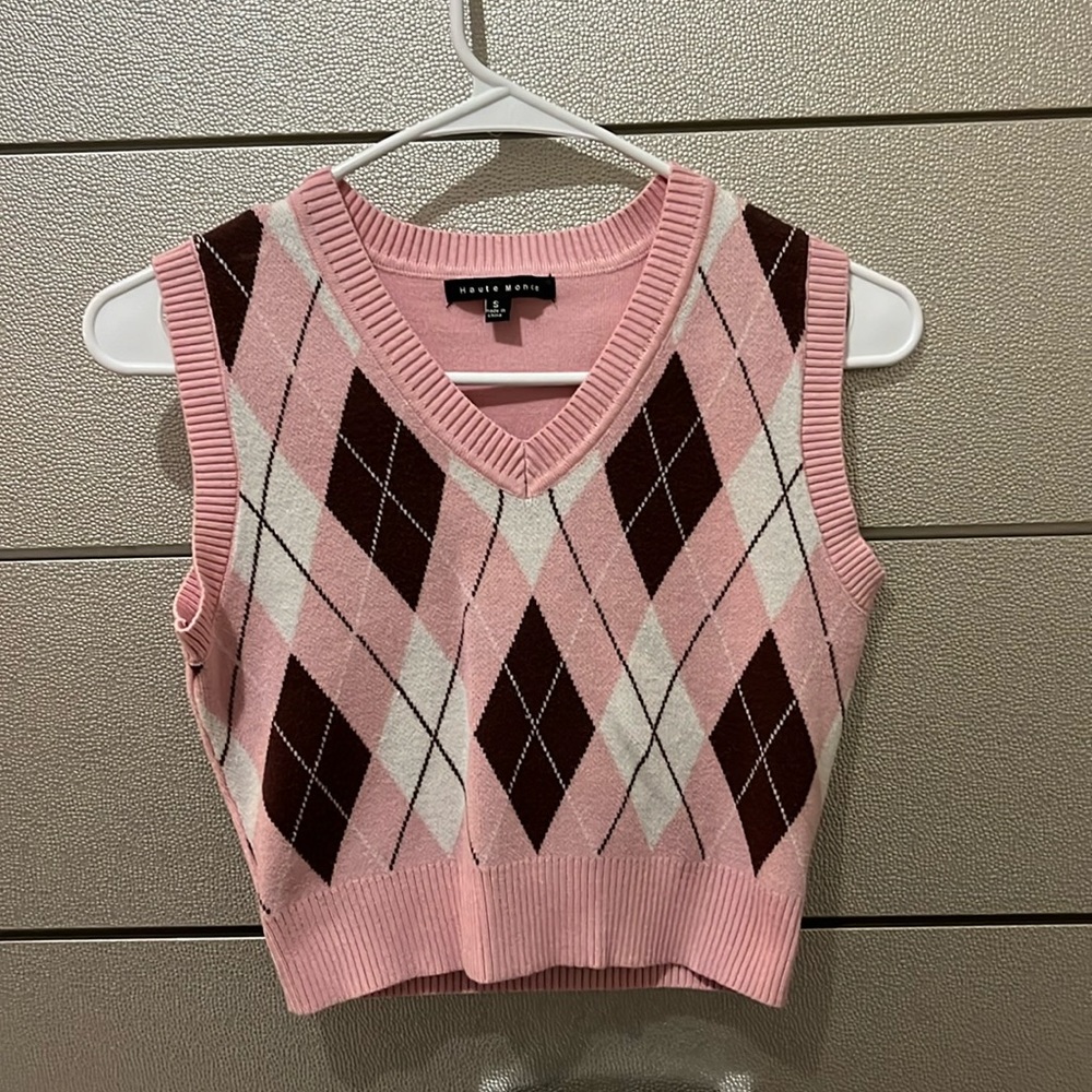 A Haute Monde sleeveless knitted vest in pink white and brown.